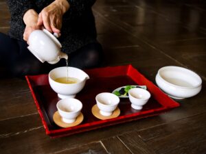Korean tea ceremony with green tea poured into white cups